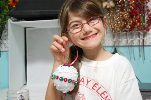 my daughter holding her button ornament