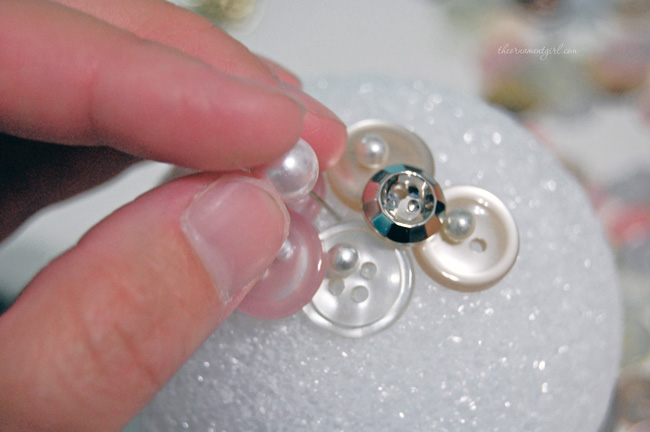 fill in spaces between buttons with pearl beads