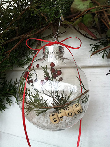 holly and letter blocks inside clear glass ornament