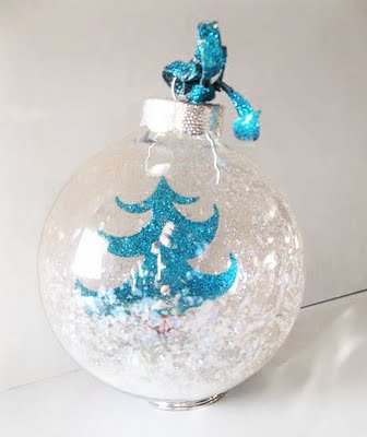 paper tree with snow in clear glass ornament