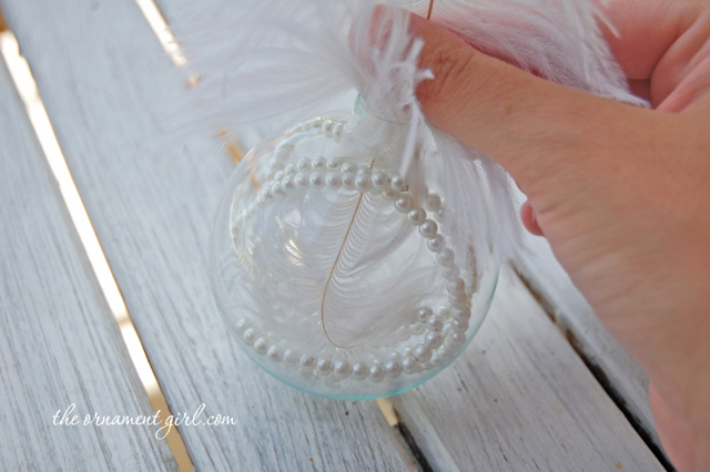 put feather inside clear glass ornament